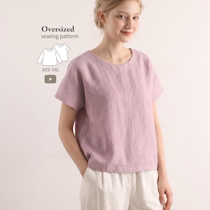 May include: A dusty pink oversized short-sleeve top with a round neckline and a loose fit. The image includes text that reads Oversized sewing pattern, a line drawing of the top, and the size range XXS-5XL with a play button icon.