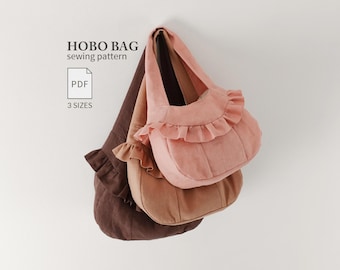 May include: A digital PDF sewing pattern for a hobo bag in three sizes. The image displays three hobo bags in shades of dark brown, tan, and light pink, each featuring a ruffled trim along the top edge and a single shoulder strap.