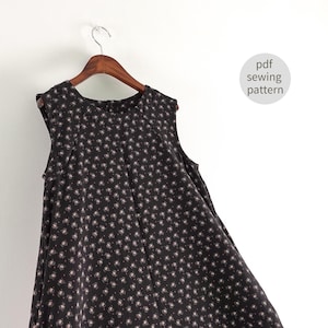 May include: A black sleeveless dress with a white floral print hanging on a wooden hanger. The dress has a round neckline and a flowy skirt. The text "pdf sewing pattern" is visible in the upper right corner of the image.