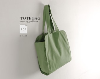 May include: A sage green tote bag with two shoulder straps. The text TOTE BAG sewing pattern is printed in black, along with a white PDF icon and the text 3 SIZES. The bag is shown hanging against a plain, light-colored background.