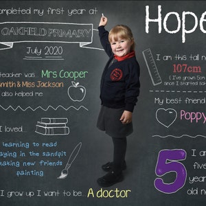 Könnte beinhalten: Eine Tafel mit einem Foto eines jungen Mädchens in Schuluniform. Auf der Tafel steht "Ich habe mein erstes Jahr an der Oakfield Primary im Juli 2020 abgeschlossen." Das Mädchen hält ein Lineal und zeigt auf die Tafel. Auf der Tafel steht auch "Hope" und "Ich bin jetzt 107 cm groß (ich bin 5 cm gewachsen, seit ich mit der Schule angefangen habe). Mein bester Freund ist... Poppy. Ich bin jetzt fünf Jahre alt!"