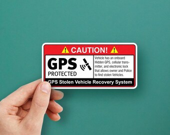 May include: A red and white sticker with a caution sign and the text "GPS Protected" and "GPS Stolen Vehicle Recovery System". The sticker warns that the vehicle has an onboard hidden GPS, cellular transmitter, and electronic lock that allows the owner and police to find stolen vehicles.
