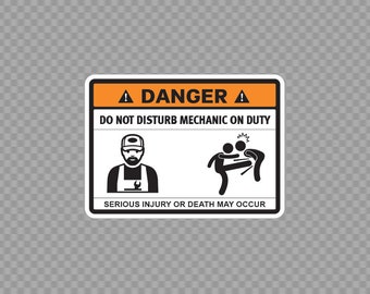 May include: A white sticker with an orange border and black text that reads "DANGER" with a triangle symbol on either side. The sticker says "DO NOT DISTURB MECHANIC ON DUTY" and has two black and white illustrations. The first illustration shows a mechanic with a wrench and the second illustration shows a person kicking another person. The sticker also says "SERIOUS INJURY OR DEATH MAY OCCUR". The sticker says "MADE IN GREECE" and "SHIPPED FROM GREECE" in black text on a white background.