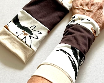Reversible wrist warmers, arm warmers, and hand warmers in beige and brown. Beige loop scarf/white loop scarf.
