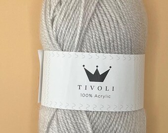 May include: A skein of light gray Tivoli 100% Acrylic yarn. The yarn is wrapped with a white label featuring the brand name, a crown graphic, and the text "100% Acrylic". The yarn is a soft, neutral color.