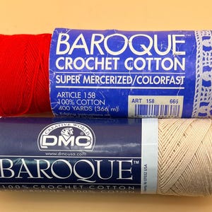 May include: Two skeins of Baroque crochet cotton yarn. The top skein is bright red with a blue label reading Baroque Crochet Cotton, Super Mercerized/Colorfast, 100% Cotton, 400 Yards. The bottom skein is beige with a blue DMC Baroque label.