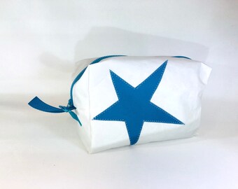 May include: White canvas zippered pouch with a large blue star sewn on the front.