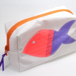 small cosmetic bag is made of upcycling canvas with an orange/purple fish