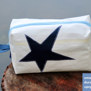 large toiletry bag is made of upcycled canvas with dark blue star