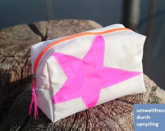 Small cosmetic bag made from upcycled sailcloth with a pink star