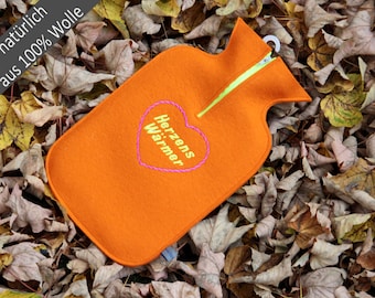 Felt cuddly hot water bottle cover in orange with “heart warmer”