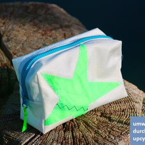 small cosmetic bag is made of upcycled canvas with green star