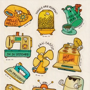 May include: A sheet of vintage stickers featuring cartoon appliances with faces. Includes a yellow telephone with "HELLO, HELLO!", a popcorn maker with "THINGS ARE POPPIN'!", and a green teapot with "FEELIN' PERKY!"