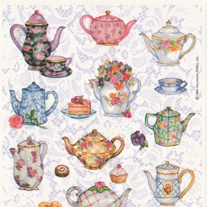 May include: A collection of colorful, decorative teapots and teacups with floral designs. The teapots vary in shape, size, and pattern, including floral, plaid, and solid colors. Some teapots are accompanied by teacups, saucers, and pastries. The background is a white lace pattern.