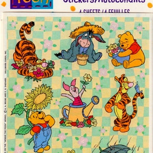 May include: Sheet of Pooh stickers featuring Winnie the Pooh, Tigger, Piglet, and Eeyore. The stickers have a checkered background with floral accents. The text "Pooh" and "Stickers/Autocollants" are visible.