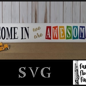 May include: A white wooden sign with the text "Come in we are awesome" in black and gold lettering. The word "awesome" is in rainbow colors with each letter on a separate block.
