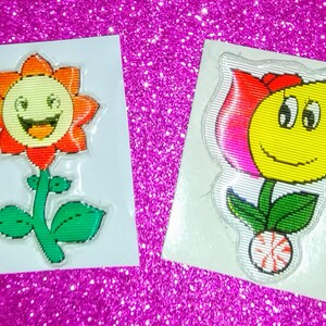 Sticker gonflé vintage des années 1980, lot de deux petites fleurs, souriant avec des roues qui tournent, scintillement/lenticulaire