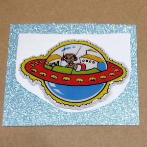 Sticker gonflé ET vintage des années 1980, l'extraterrestre dans son vaisseau spatial - si mignon ! - Au dos de l'original