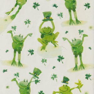 May include: A sheet of stickers featuring green frogs wearing green hats. The frogs are in various poses, some are jumping, some are standing, and some are holding their hats. The stickers are surrounded by green shamrocks.