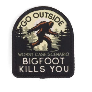 May include: A black and white patch with the text "GO OUTSIDE" at the top and "BIGFOOT KILLS YOU" at the bottom. The patch features a brown Bigfoot silhouette walking through a forest scene.