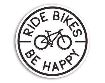 May include: A circular sticker with a white background and a black border. In the center is a black line drawing of a mountain bike. The text RIDE BIKES is arched above the bike, and the text BE HAPPY is arched below the bike in black.