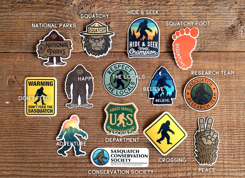 May include: A collection of 14 colourful stickers featuring a cartoon Sasquatch in various poses and settings. The stickers include phrases like "Squatchy", "Hide & Seek World Champion", "Respect the Locals", "Believe", "Sasquatch Research Team", "Warning Don't Feed the Sasquatch", "Adventure", "Sasquatch Conservation Society", "Crossing", and "Peace".