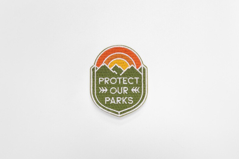 Centered small in a pale white field, the Protect Our Parks patch keeps its shield shape crisp.