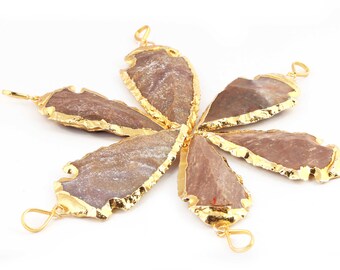 May include: Six brown agate arrowhead pendants with gold-plated edges. The pendants are arranged in a starburst pattern.