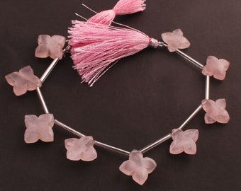 May include: A strand of pink rose quartz butterfly beads with silver spacers and a pink tassel.