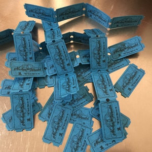 May include: A pile of blue paper tickets with the text "Miba World" and "1 Ticket" printed on them.