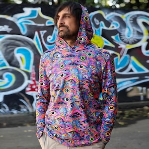 May include: A long-sleeved hooded sweatshirt with a psychedelic print of colorful eyes. The hoodie is black with a pink, blue, green, and yellow eye pattern.