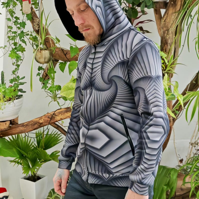 May include: A black and white patterned hoodie with a zipper closure. The pattern features a swirling, geometric design.