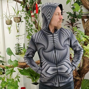 May include: A black and gray hooded sweatshirt with a geometric pattern. The pattern is made up of repeating shapes that create a sense of depth and movement.