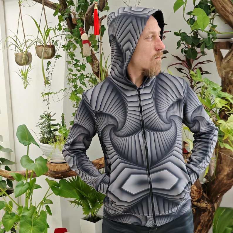 May include: A black and gray hooded sweatshirt with a geometric pattern. The pattern is made up of repeating shapes that create a sense of depth and movement.
