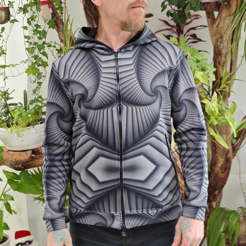 May include: A black and gray zip-up hoodie with a geometric pattern. The pattern is made up of repeating shapes that create a 3D effect.