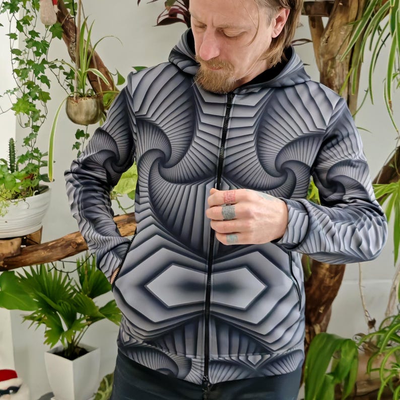 May include: A black and gray zip-up hoodie with a geometric pattern. The pattern features a swirling, 3D effect.