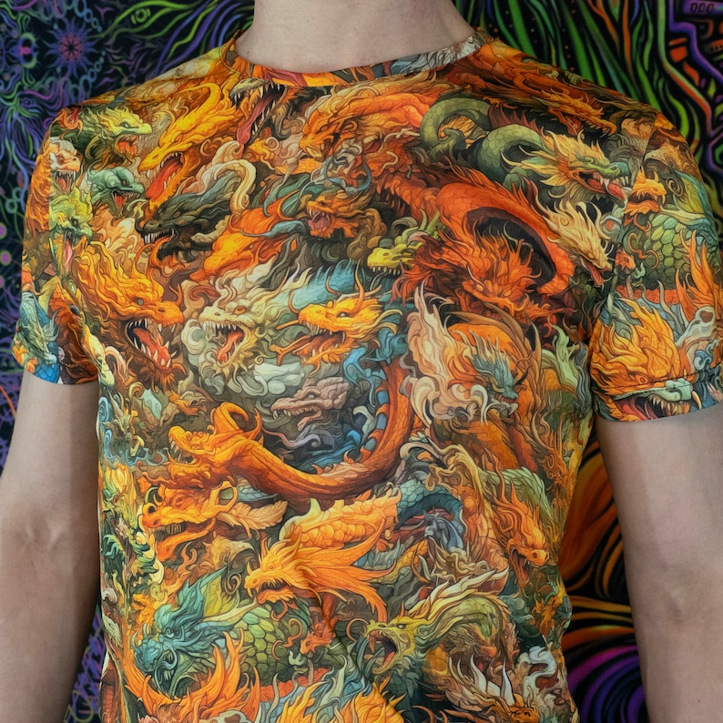 May include: A short-sleeved t-shirt featuring a vibrant, all-over print of numerous detailed dragons. The dragons are depicted in shades of orange, yellow, green, and blue, creating a dynamic and eye-catching design. The shirt's design is intricate and artistic.