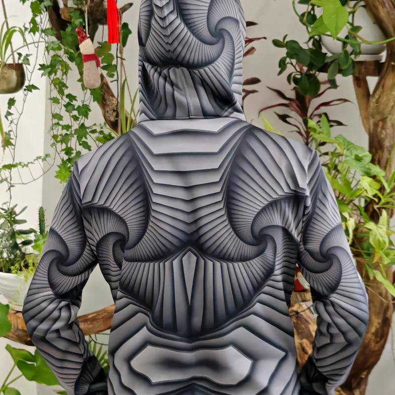 May include: A black and white hooded sweatshirt with a geometric pattern of swirling lines and shapes.