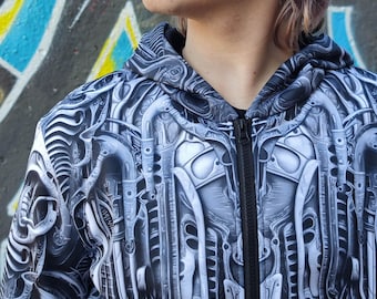 May include: A black and white zip-up hoodie with a detailed, intricate, mechanical design. The design features a repeating pattern of gears, pipes, and other industrial elements.