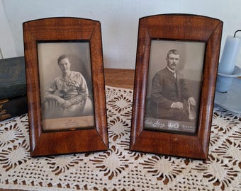 Pair of antique wooden photo frames with original photos