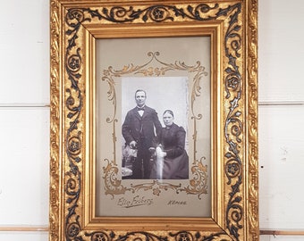 Richly decorated antique photo frame with original photo