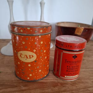 Two old cylindrical tin cans
