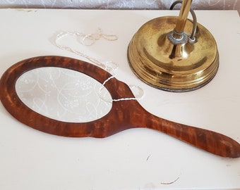 Antique wooden hand mirror with beer glaze