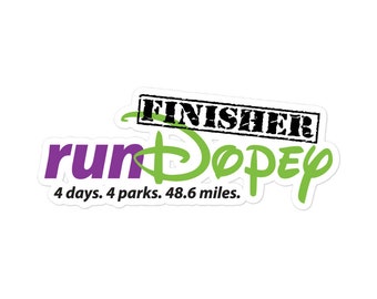 May include: A green and purple sticker with the text "runDisney" and "FINISHER" in a black stamp. The text "4 days. 4 parks. 48.6 miles." is below the main text.