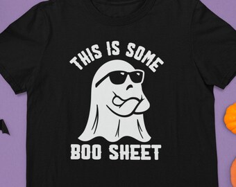 May include: Black t-shirt with a white ghost wearing sunglasses and the text "This is some boo sheet."