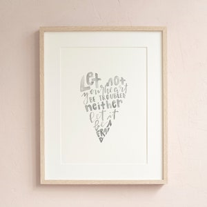 May include: A framed print with a watercolor heart design. The heart is made up of the words "Let not your heart be troubled neither let it be afraid".