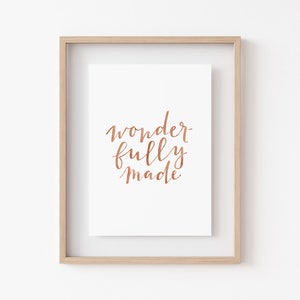May include: A framed print with the text "wonderfully made" in copper foil lettering on a white background.