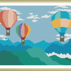 Può includere: Tre mongolfiere galleggiano sopra una catena montuosa. I palloni sono colorati, con strisce rosa, gialle, blu, verdi e arancioni. Le montagne sono blu e verdi, e il cielo è azzurro chiaro con nuvole bianche.