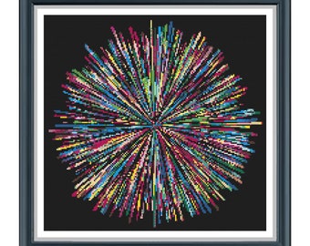 May include: A framed abstract art print with a colorful, radial design resembling a burst of fireworks on a black background.