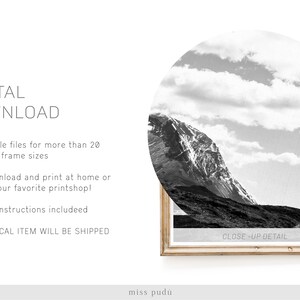 May include: A black and white photograph of a mountain range with a cloudy sky. The image is framed in a light wood frame. The text "CLOSE-UP DETAIL" is printed on the bottom of the frame.